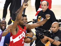 Toronto Raptors forward Kawhi Leonard (2) and guard Kyle Lowry, back, celebrate after the Raptors defeated the Golden State Warriors 114-110 in Game 6 of basketball s NBA Finals, Thursday, June 13, 2019, in Oakland, Calif. (Frank Gunn/The Canadian Press via AP)