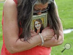 Melany Zoumadakis clutches a photo of her daughter, Tanna Jo Fillmore, on Friday, April 26, 2019, in Salt Lake City. Fillmore killed herself in the Duchesne County Jail in 2016, after repeatedly calling her mother, saying she was being denied her prescription medicines that had stabilized her. Her mother has filed suit. (AP Photo/Rick Bowmer)