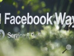 FILE - In this April 25, 2019, file photo an address sign for Facebook Way is shown in Menlo Park, Calif. Facebook unveiled a broad plan Tuesday, June 18, to create a new digital currency. (AP Photo/Jeff Chiu, File)