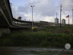 Pedestrian commuters wait in line to enter Brownsville, Texas, on the Puerta Mexico bridge across the Rio Grande, seen from downtown Matamoros, Tamaulipas state, Mexico, Wednesday, June 26, 2019. Hundreds of migrants, some who have been in line for months, are awaiting their turn on the Mexican side to request asylum in the U.S. (AP Photo/Rebecca Blackwell)