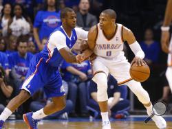 FILE - In this Monday, May 5, 2014 file photo, Oklahoma City Thunder guard Russell Westbrook (0) drives against Los Angeles Clippers guard Chris Paul (3) in the first quarter of Game 1 of the Western Conference semifinal NBA basketball playoff series in Oklahoma City. A person with knowledge of the situation says the Oklahoma City Thunder have traded Russell Westbrook to the Houston Rockets for Chris Paul, a shake up of top point guards and a move that reunites Westbrook with James Harden, Thursday, July 11