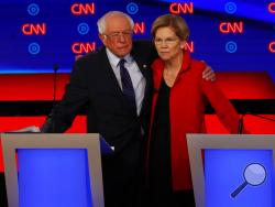 Sen. Bernie Sanders, I-Vt., and Sen. Elizabeth Warren, D-Mass., embrace after the first of two Democratic presidential primary debates hosted by CNN Tuesday, July 30, 2019, in the Fox Theatre in Detroit. (AP Photo/Paul Sancya)
