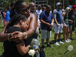 Mourners gather at a vigil following a nearby mass shooting, Sunday, Aug. 4, 2019, in Dayton, Ohio. Multiple people in Ohio have been killed in the second mass shooting in the U.S. in less than 24 hours, and the suspected shooter is also deceased, police said. (AP Photo/John Minchillo)