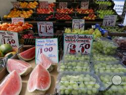 A fruit stall displays fruit at a market in London, Wednesday, Aug. 7, 2019. The U.K. food industry is asking the government to set aside competition rules so companies can coordinate supply decisions to combat shortages in the event Britain leaves the European Union without an agreement on future trade relations. (AP Photo/Kirsty Wigglesworth)