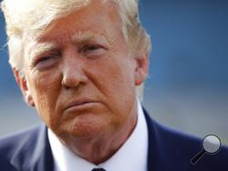 In this Aug. 18, 2019, photo, President Donald Trump speaks with reporters before boarding Air Force One at Morristown Municipal Airport in Morristown, N.J. (AP Photo/Patrick Semansky)