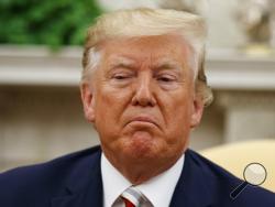 President Donald Trump pauses while speaking during a meeting with Romanian President Klaus Iohannis in the Oval Office of the White House, Tuesday, Aug. 20, 2019, in Washington. (AP Photo/Alex Brandon)
