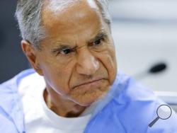 FILE - In this Wednesday, Feb. 10, 2016, file photo, Sirhan Sirhan reacts during a parole hearing at the Richard J. Donovan Correctional Facility in San Diego. Sirhan, Sen. Robert F. Kennedy’s assassin, is hospitalized in stable condition after being stabbed by a fellow inmate at a Southern California prison, Friday, Aug. 30, 2019. (AP Photo/Gregory Bull, Pool, File)