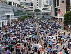 Pro-democracy protestors march in central Hong Kong, Saturday, Aug. 31, 2019. Large crowds of protesters are gathering and marching in central Hong Kong as police ready for possible confrontations near the Chinese government's main office or elsewhere in the city. The black-shirted protesters have taken over parts of major roads and intersections Saturday as they rally and march. (AP Photo/Kin Cheung)
