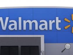 A Walmart logo is attached to the outside of a Walmart store, Tuesday, Sept. 3, 2019, in Walpole, Mass. Walmart is going back to its folksy hunting heritage and getting rid of anything that's not related to a hunting rifle after two mass shootings in its stores in one week left 24 people dead in August of 2019. (AP Photo/Steven Senne)