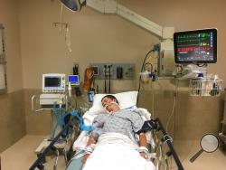 This May 2018, photo provided by Joseph Jenkins shows his son, Jay, in the emergency room of the Lexington Medical Center in Lexington, S.C. Jay Jenkins suffered acute respiratory failure and drifted into a coma, according to his medical records, after he says he vaped a product labeled as a smokable form of the cannabis extract CBD. Lab testing commissioned as part of an Associated Press investigation into CBD vapes showed the cartridge that Jenkins says he puffed contained a synthetic marijuana compound b