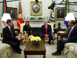 President Donald Trump talks about a plan to ban most flavored e-cigarettes, in the Oval Office of the White House, Wednesday, Sept. 11, 2019, in Washington. From left, acting FDA Commissioner Ned Sharpless, first lady Melania Trump, Trump, and Secretary of Health and Human Services Alex Azar. (AP Photo/Evan Vucci)