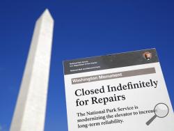 A sign greets visitors outside of the Washington Monument during a press preview tour ahead of the monument's official reopening, Wednesday, Sept. 18, 2019, in Washington. The monument, which has been closed to the public since August 2016, is scheduled to re-open Thursday, Sept. 19. (AP Photo/Patrick Semansky)