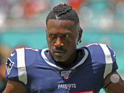 In this Sunday, Sept. 15, 2019, photo, New England Patriots wide receiver Antonio Brown waits for the team's NFL football game against the Miami Dolphins to begin in Miami Gardens, Fla. \Brown was released by the Patriots on Friday, Sept. 20, after a second woman accused him of sexual misconduct. (David Santiago/Miami Herald via AP)