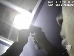 In this Saturday, Oct. 12, 2019, image made from a body camera video released by the Fort Worth Police Department an officer shines a flashlight into a window in Fort Worth, Texas. A black woman was fatally shot by a white Fort Worth, Texas, officer inside the home early Saturday after police were called to the residence for a welfare check, authorities said. The Tarrant County Medical Examiner's Office identified her as 28-year-old Atatiana Jefferson. (Fort Worth Police Department via AP)