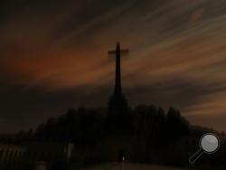 In this photo taken on Monday, Oct. 14, 2019, Guardia Civil officers stand guard in front of The Valley of the Fallen mausoleum near El Escorial, outskirts of Madrid, After a tortuous judicial and public relations battle, Spain's Socialist government has announced that Gen. Francisco Franco's embalmed body will be relocated from a controversial shrine to a small public cemetery where the former dictator's remains will lie along with his deceased wife. (AP Photo/Manu Fernandez)