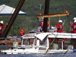 FILE - In this July 23, 2018 file photo, a duck boat that sank in Table Rock Lake in Branson, Mo., is raised after it went down the evening of July 19 after a thunderstorm generated near-hurricane strength winds, killing 17 people. The National Transportation Safety Board on Wednesday, Nov. 13, 2019, released a "Safety Recommendation Report" on the accident. The NTSB says the Coast Guard has repeatedly ignored safety recommendations that could have made tourist duck boats safer and potentially prevented the