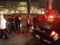 People leave Vivint Smart Home Arena after the Utah Jazz's home arena was evacuated because of a suspicious package following the team's NBA basketball game against the Golden State Warriors on Friday, Nov. 22, 2019, in Salt Lake City. Most fans had already left the building when players, coaches and reporters were instructed to leave the arena following Utah's 113-109 victory. (AP Photo/Rick Bowmer)