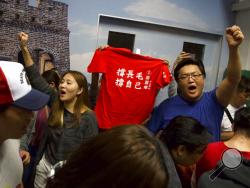 Supporters of pro-democracy candidate Leung Kwok Hung, also known as Long Hair, react after his election loss at a polling station in Hong Kong, early Monday, Nov. 25, 2019. Vote counting was underway in Hong Kong early Monday after a massive turnout in district council elections seen as a barometer of public support for pro-democracy protests that have rocked the semi-autonomous Chinese territory for more than five months.(AP Photo/Ng Han Guan)