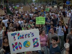 FILE- In this Friday, Sept. 27, 2019 file photo, people march during a worldwide protest demanding action on climate change in Barcelona, Spain. 'Generation Greta' has become a vocal force in the debate over global warming. (AP Photo/Joan Monfort, file)