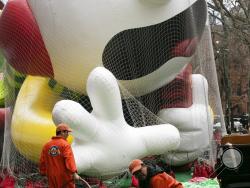 Workers carry a helium hose as the Diary of a Wimpy Kid balloon is inflated, Wednesday, Nov. 27, 2019 in New York. The city's big Macy's Thanksgiving Day Parade on Thursday will take place amid strong winds that could potentially ground the giant character balloons. (AP Photo/Mark Lennihan)