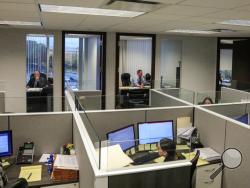 This Tuesday, Oct. 29, 2019, photo taken at the law firm of Slater, Slater and Schulman, shows lawyers Linc Leder, top left, and Michael Werner, top right, in their offices, while paralegals work in their cubicles, in Melville, N.Y. Attorney Adam Slater said since New York state opened its one-year window allowing sex abuse suits with no statute of limitations, his firm has signed up nearly 300 new clients and hired a half-dozen new paralegals to field calls. (AP Photo/Bebeto Matthews)