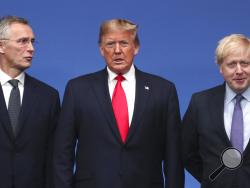 NATO Secretary General Jens Stoltenberg, left, and British Prime Minister Boris Johnson, right, welcome U.S. President Donald Trump during a NATO leaders meeting at The Grove hotel and resort in Watford, Hertfordshire, England, Wednesday, Dec. 4, 2019. NATO Secretary-General Jens Stoltenberg rejected Wednesday French criticism that the military alliance is suffering from brain death, and insisted that the organization is adapting to modern challenges. (AP Photo/Francisco Seco)