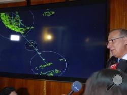 In this image made from video, Gen. Eduardo Mosqueira, right, of the Fourth Air Brigade speaks to the media next to a map of the area where the airplane is missing, in Punta Arenas, Chile, Monday, Dec. 9, 2019. Chile's air force lost radio contact with a transport plane carrying 38 people on a flight Monday evening to the country's base in Antarctica, and authorities indicated several hours later that they were not optimistic about the aircraft's fate. The military said earlier that it had declared an alert