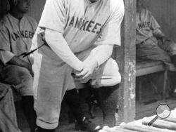 FILE - In this July 19, 1929, file photo New York Yankees' Babe Ruth stands in the dugout with a strained muscle in his left leg during a game in Cleveland. The bat used by the legendary baseball player to hit his 500th home run was auctioned on Saturday, Dec. 14, 2019, for more than $1 million. SCP Auctions, who held the auction in Laguna Niguel, Calif., didn't identify the buyer. (AP Photo/File)
