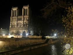 This photo taken on Monday Dec. 16, 2019 shows Notre Dame Cathedral lit up at night, in Paris. Notre Dame Cathedral kept holding services during two world wars as a beacon of hope amid bloodshed and fear. It took a fire in peacetime to finally stop Notre Dame from celebrating Christmas Mass for the first time in more than two centuries. (AP Photo/Michel Euler)