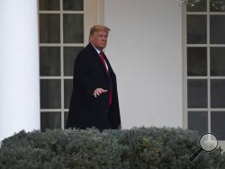 President Donald Trump walks along the colonnade of the White House in Washington, Monday, Jan. 13, 2020. A U.S. cybersecurity company says Russian military agents successfully hacked the Ukrainian gas company at the center of the scandal that led to President Donald Trump's impeachment. (AP Photo/Susan Walsh)