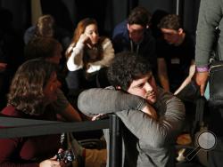 People wait for results at a caucus night campaign rally for democratic presidential candidate former Vice President Joe Biden on Monday, Feb. 3, 2020, in Des Moines, Iowa. (AP Photo/John Locher)