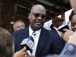 FILE - In this Monday, Dec. 16, 2019 file photo, Curtis Flowers speaks with reporters as he exits the Winston-Choctaw Regional Correctional Facility in Louisville, Miss. Mississippi's new attorney general must decide whether to take a quadruple murder case to a seventh trial. Curtis Flowers has had two mistrials and four reversed convictions in connection with the 1996 slayings of four people at a furniture store. (AP Photo/Rogelio V. Solis, File)