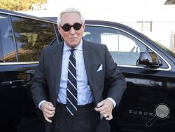 FILE - In this Nov. 6, 2019 file photo, Roger Stone arrives at Federal Court for the second day of jury selection for his federal trial, in Washington. The Justice Department said Tuesday it will take the extraordinary step of lowering the amount of prison time it will seek for Roger Stone, an announcement that came just hours after President Donald Trump complained that the recommended sentence for his longtime ally and confidant was “very horrible and unfair." (AP Photo/Cliff Owen)