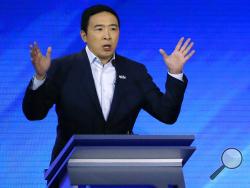 In this Feb. 7, 2020, photo, Democratic presidential candidate entrepreneur Andrew Yang speaks during a Democratic presidential primary debate at Saint Anselm College in Manchester, N.H. (AP Photo/Elise Amendola)