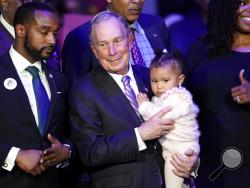 Democratic presidential candidate and former New York City Mayor Michael Bloomberg is joined on stage by supporters during his campaign launch of "Mike for Black America," at the Buffalo Soldiers National Museum, Thursday, Feb. 13, 2020, in Houston. (AP Photo/David J. Phillip)