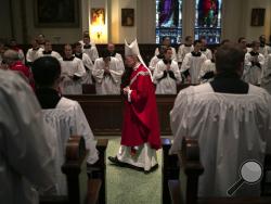 Bishop Timothy Senior processes down the aisle at the start of a Mass at St. Charles Borromeo Seminary in Wynnewood, Pa., on Wednesday, Feb. 5, 2020. Senior leads the seminary and says, despite scandals in the Catholic Church, men keep responding to the call to the priesthood. (AP Photo/Wong Maye-E)