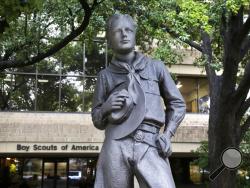 In this Wednesday, Feb. 12, 2020, photo, a statue stands outside the Boys Scouts of America headquarters in Irving, Texas. The Boy Scouts of America has filed for bankruptcy protection as it faces a barrage of new sex-abuse lawsuits. The filing Tuesday, Feb. 18, in Wilmington, Delaware, is an attempt to work out a potentially mammoth compensation plan for abuse victims that will allow the 110-year-old organization to carry on. (AP Photo/LM Otero)