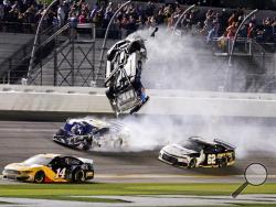 Ryan Newman, top center, goes airborne as he is hit by Corey LaJoie (32) on the final lap of the NASCAR Daytona 500 auto race at Daytona International Speedway, Monday, Feb. 17, 2020, in Daytona Beach, Fla. Sunday's race was postponed because of rain. (AP Photo/Terry Renna)