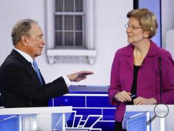 Democratic presidential candidates, former New York City Mayor Mike Bloomberg, left, and Sen. Elizabeth Warren, D-Mass., talk during a break at a Democratic presidential primary debate Wednesday, Feb. 19, 2020, in Las Vegas, hosted by NBC News and MSNBC. (AP Photo/John Locher)