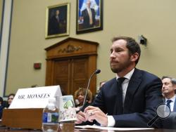 FILE - In this July 25, 2019, file photo, Juul Labs co-founder and Chief Product Officer James Monsees testifies before a House Oversight and Government Reform subcommittee on Capitol Hill in Washington, during a hearing on the youth nicotine epidemic. Vaping giant Juul Labs has donated thousands of dollars to court state attorneys general. But the lobbying strategy may be backfiring. (AP Photo/Susan Walsh, file)