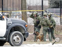 Police work outside the Molson Coors Brewing Co. campus in Milwaukee on Wednesday, Feb. 26, 2020, after reports of a possible shooting. (AP Photo/Morry Gash)