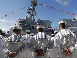 FILE - In this Saturday, July 27, 2019, file photo, sailors stand during a commissioning ceremony for the U.S. Navy guided missile destroyer USS Paul Ignatius, at Port Everglades in Fort Lauderdale, Fla. The U.S. Navy is releasing a strategy that describes plans to overhaul its approach to education because the nation no longer has a massive economic and technological edge over potential adversaries. (AP Photo/Lynne Sladky, File)