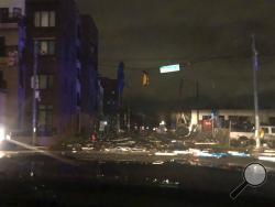 Debris scattered across an intersection Tuesday, March 3, 2020, in downtown Nashville, Tenn. The National Weather Service in Nashville confirmed a tornado touched down in the area. (Celia Darrough via AP)
