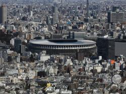 FILE - In this March 3, 2020, file photo, the New National Stadium, a venue for the opening and closing ceremonies at the Tokyo 2020 Olympics, is seen from Shibuya Sky observation deck in Tokyo. The tentacles of cancelling the Tokyo Olympics — or postponing or staging it in empty venues — would reach into every corner of the globe, much like the spreading virus that now imperils the opening ceremony on July 24. (AP Photo/Jae C. Hong, File)