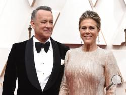 FILE - In this Feb. 9, 2020 file photo, Tom Hanks, left, and Rita Wilson arrive at the Oscars at the Dolby Theatre in Los Angeles. The couple have tested positive for the coronavirus, the actor said in a statement Wednesday, March 11. The 63-year-old actor said they will be "tested, observed and isolated for as long as public health and safety requires." (Photo by Jordan Strauss/Invision/AP, File)
