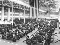 FILE - In this April 3, 1944, file photo Bofors guns used by the Army and Navy are shown lined up at the Firestone Tire & Rubber Co. in Akron, Ohio. Not since World War II when factories converted from making automobiles to making tanks, Jeeps and torpedos has the entire nation been asked to truly sacrifice for a greater good. (AP Photo, File)