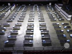 A federal medical station is set up at Temple University's Liacouras Center in Philadelphia, Monday, March 30, 2020, to accommodate an influx in hospital patients due to the coronavirus outbreak. (AP Photo/Matt Rourke)