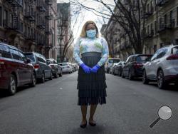 Tiffany Pinckney poses for a portrait in the Harlem neighborhood of New York on April 1, 2020. After a period of quarantine at home separated from her children, she has recovered from COVID-19. Pinckney became one of the nations first donors of "convalescent plasma." Doctors around the world are dusting off a century-old treatment for infections: Infusions of blood plasma teeming with immune molecules that helped survivors beat the new coronavirus. (AP Photo/Marshall Ritzell)