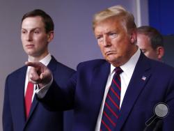 President Donald Trump points to a reporter to ask a question as he speaks about the coronavirus in the James Brady Press Briefing Room of the White House, Thursday, April 2, 2020, in Washington, as White House adviser Jared Kushner listens. (AP Photo/Alex Brandon)