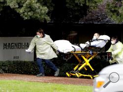 A patient is evacuated from the Magnolia Rehabilitation and Nursing Center in Riverside, Calif., Wednesday, April 8, 2020. More than 80 patients from a Riverside skilled nursing facility are being evacuated this morning to other healthcare locations throughout Riverside County, Calif. (AP Photo/Chris Carlson)